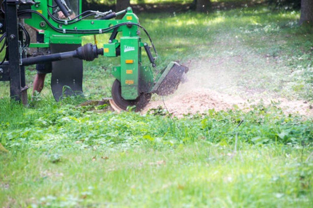 Professional stump grinding machine removing a tree stump below ground level during stump grinding and removal service in Wentzville, MO.
