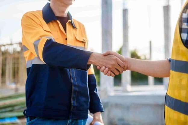 Evergreen Tree Service representative shaking hands with a satisfied homeowner after completing professional emergency tree service in Wentzville, MO.
